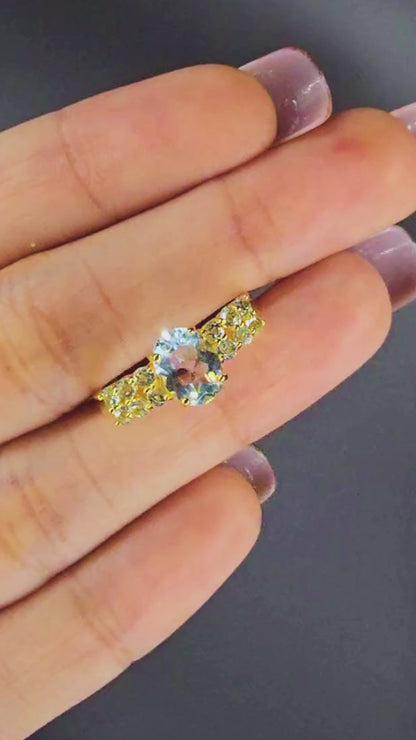 NYX – LARGE OVAL NATURAL BLUE TOPAZ GEMSTONE RING PLATED IN YELLOW GOLD