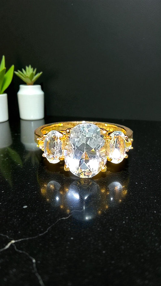 HARMONIA – BLUE TOPAZ TRILOGY GEMSTONE RING PLATED IN YELLOW GOLD